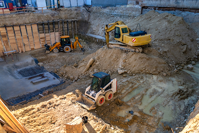 Heavy construction equipment working at the construction site.