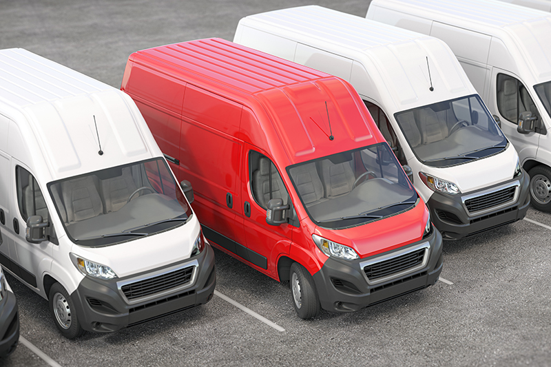Red delivery van in a row of white vans. Best express delivery a